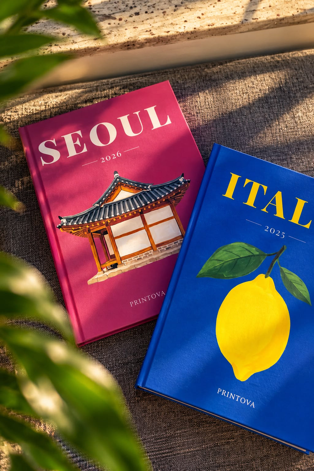 Printova Seoul and Italy hardcover albums in afternoon light